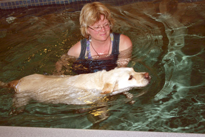 Cindy Horsfall of La Paw Spa helps her client Maggie though the waters during a warm water therapy session.